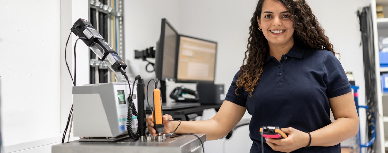Calibration of thermodynamic measuring equipment A woman calibrates an immersion sensor for measuring temperature in a laboratory