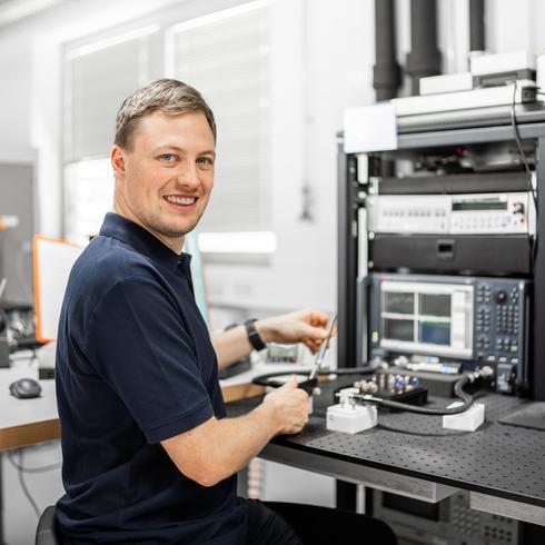 Calibration of high-frequency measuring instruments A man calibrates measuring instruments in the high-frequency range