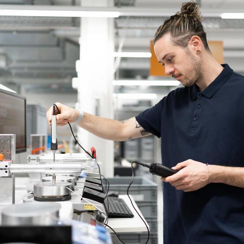 Calibration of surface temperature sensors A man in a laboratory calibrates a surface temperature sensor